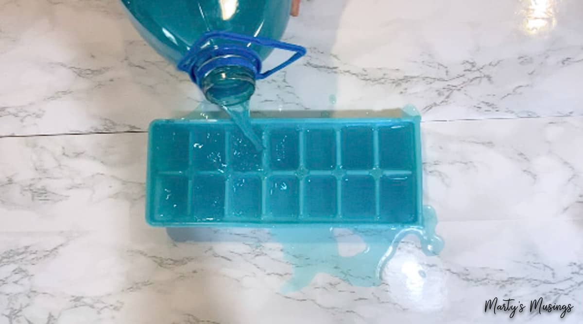 Blue Hawaiian Punch poured into ice cube tray