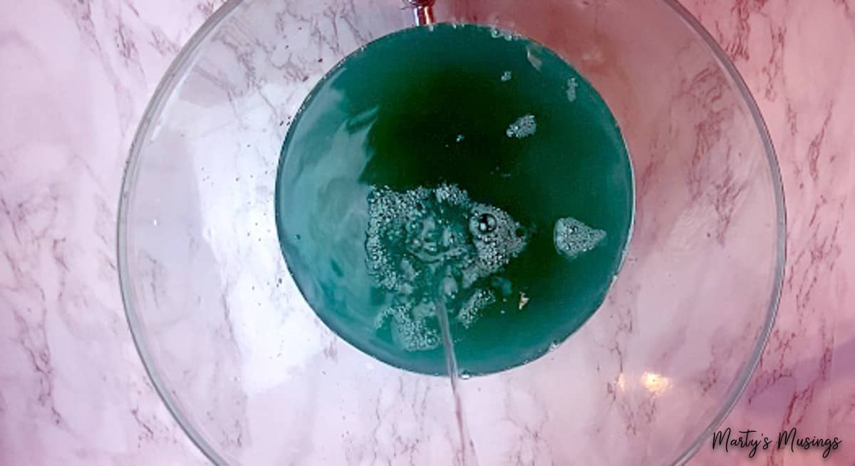 Ginger ale added to blue party punch