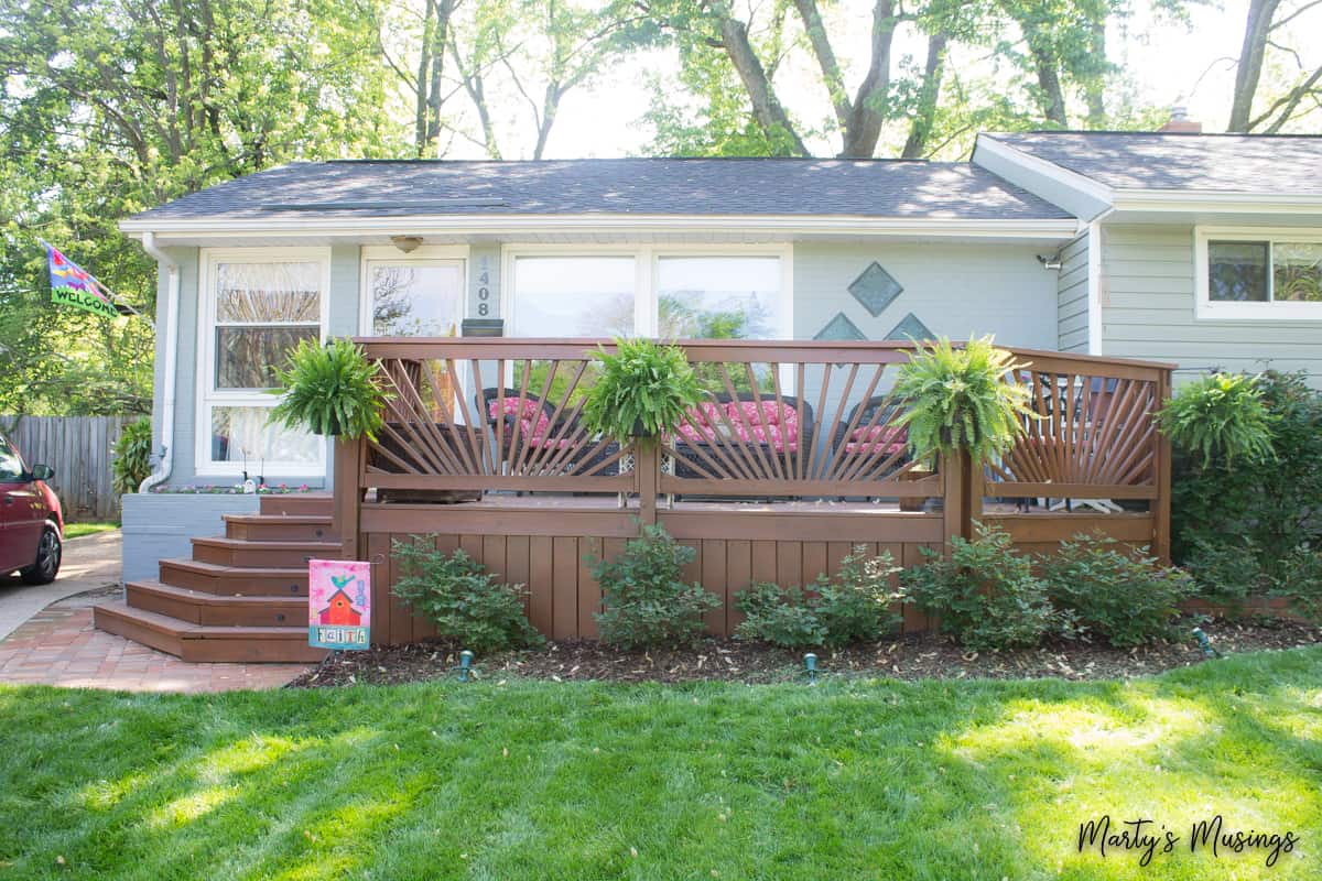 ranch style home with stained deck on front