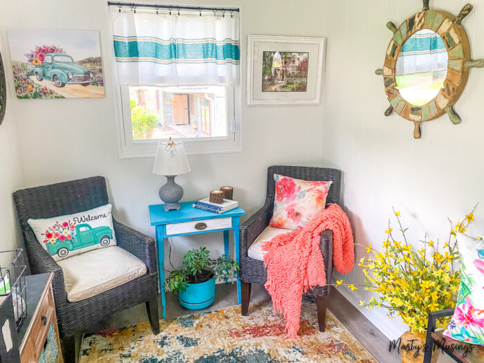 Sunroom with aqua and coral pillows and accents