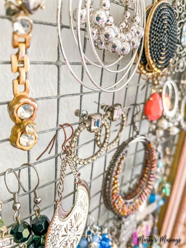 closeup of earring hanging on chicken wire frame