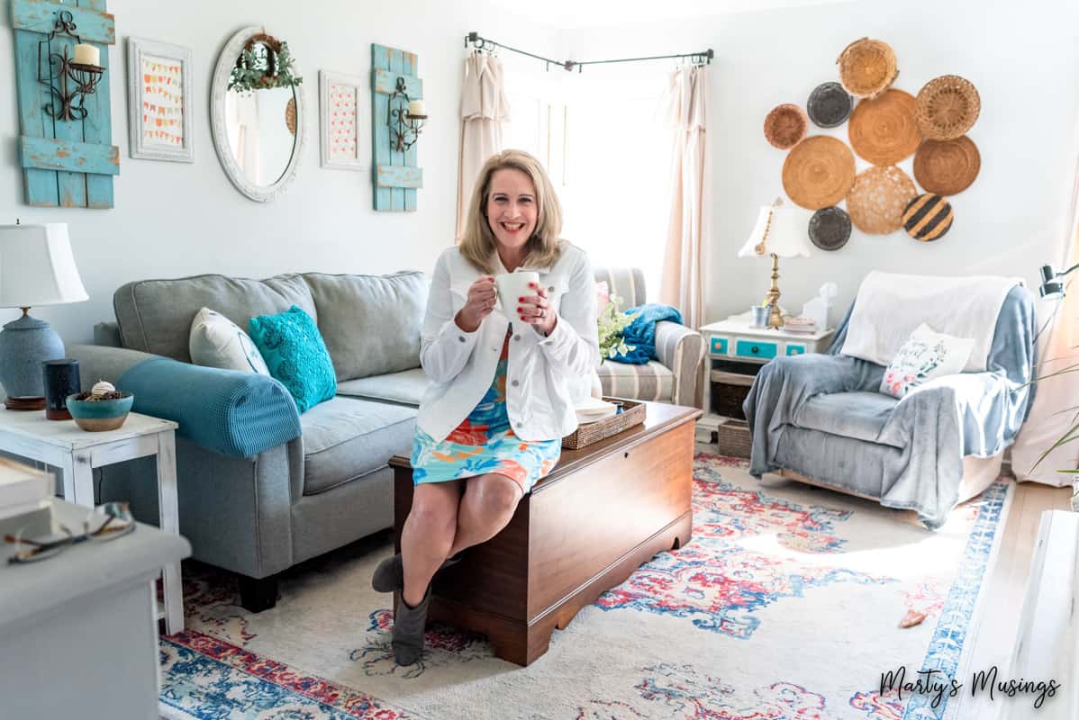 woman with coffee mug in hand in cottage living room