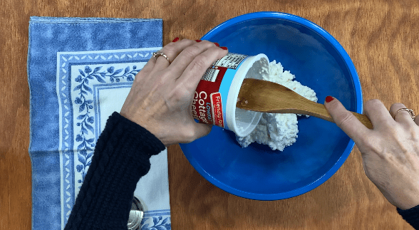Pour cottage cheese into blue bowl