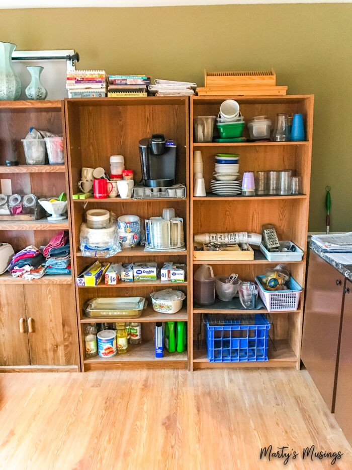 wall of bookshelves with kitchen items on them