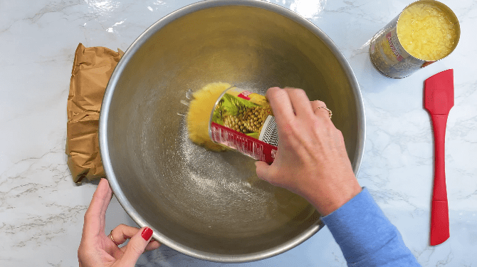 Pour crushed pineapple into metal bowl