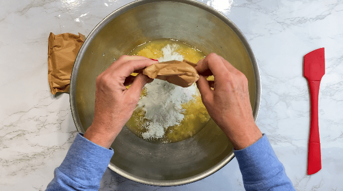 Pour pistachio pudding mix on top of crushed pineapples