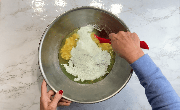 Stir pistachio pudding into crushed pineapples in metal bowl