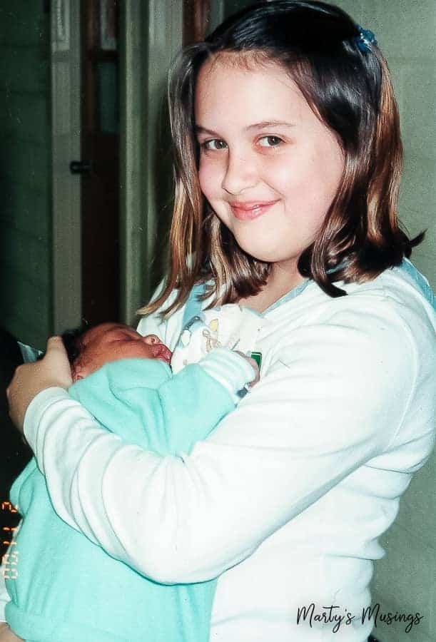 Young girl holding baby