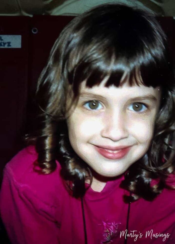 Young girl with pink shirt and curly hair