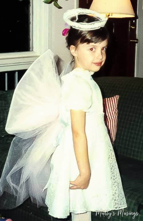 Young girl dressed up for Halloween in angel costume
