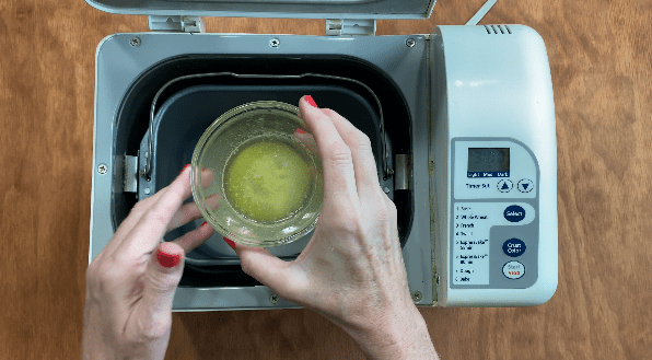 Pour melted butter into bread machine for white bread