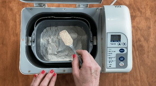 Add yeast to bread machine ingredients to make white bread