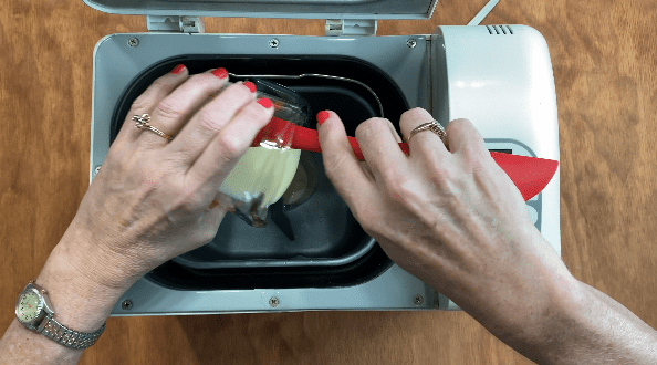 Pour sweetened condensed milk into bread machine