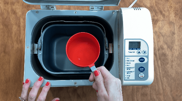 Pour water into bread machine 