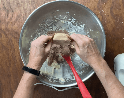 Pour pudding mix into dough mixture in metal bowl