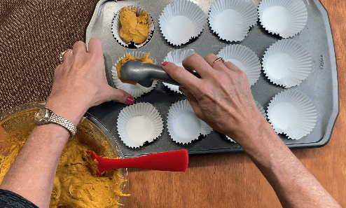 scoop pumpkin muffin dough into muffin cups