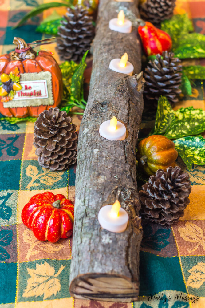 log filled with openings for candles and fall decorations