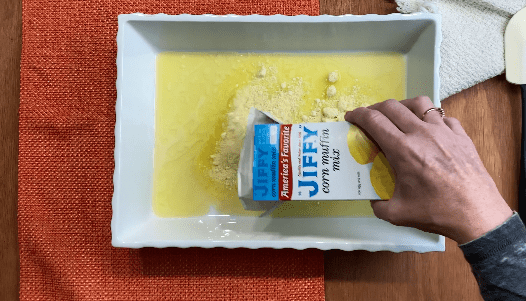 pour Jiffy Corn muffin mix into white casserole dish