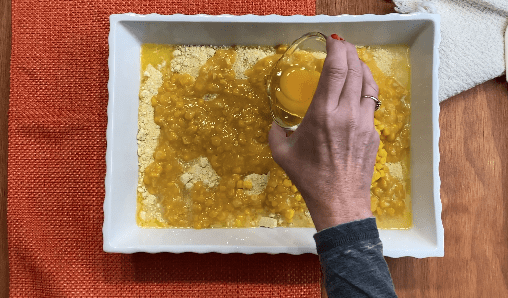 Pour egg into corn mixture in white dis