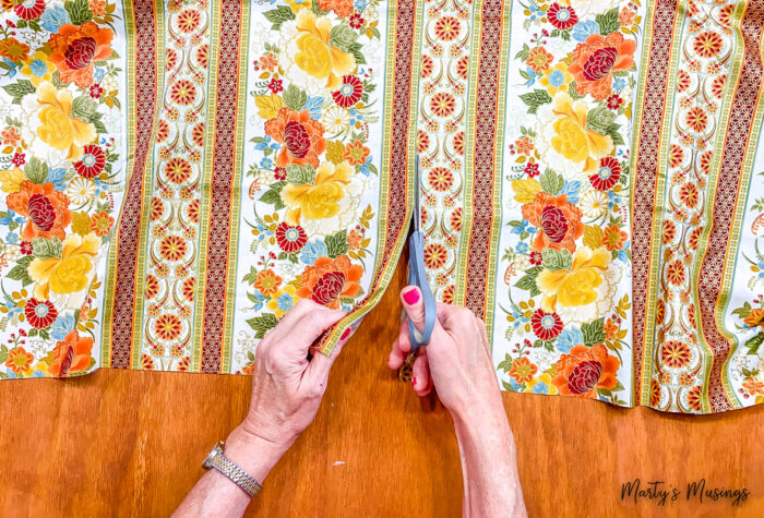 cutting floral and striped fabric for fall table runner