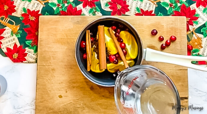 Pour water over natural ingredients for potpourri