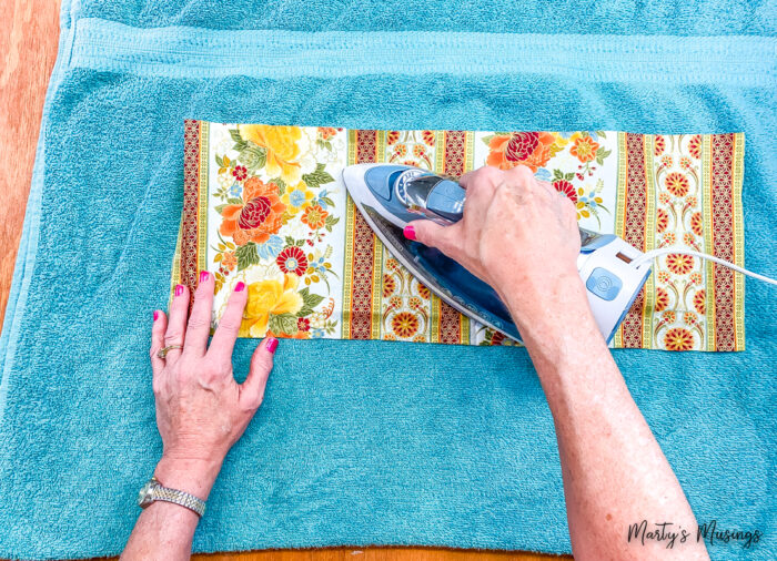 iron floral fabric on top of blue towel