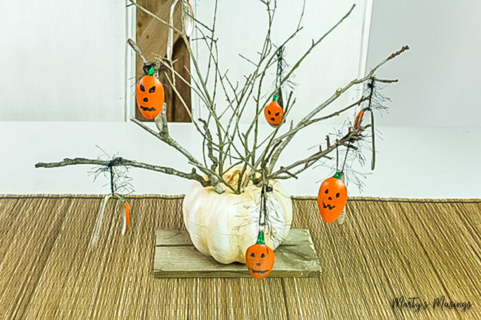 Pumpkin stuffed with branches with painted pumpkin spoons