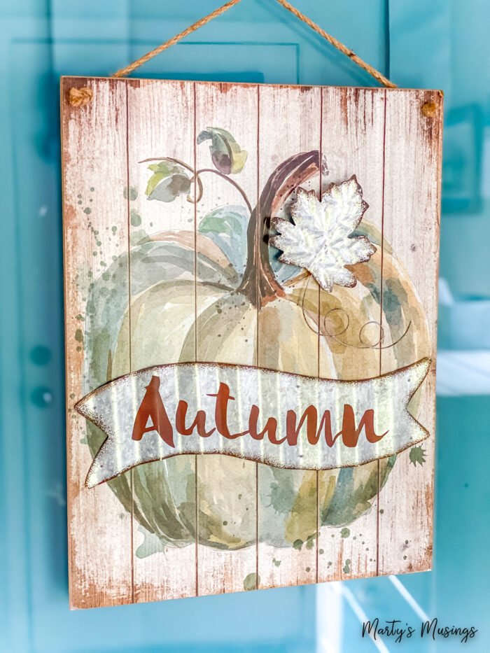 Autumn sign with blue and brown pumpkin