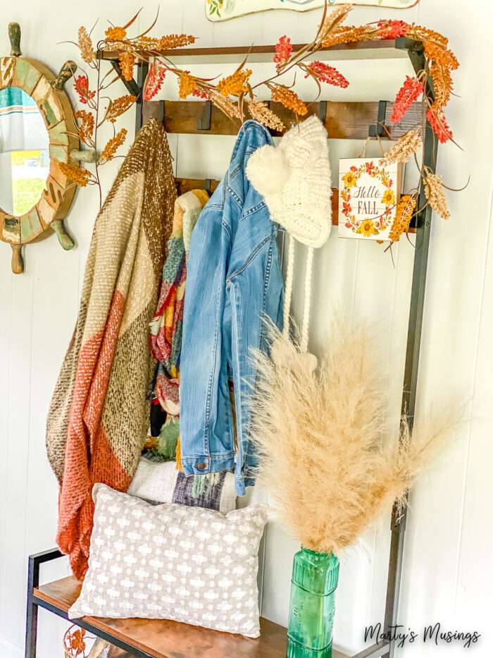 Fall fashions and colors hanging on hall tree with rustic garland