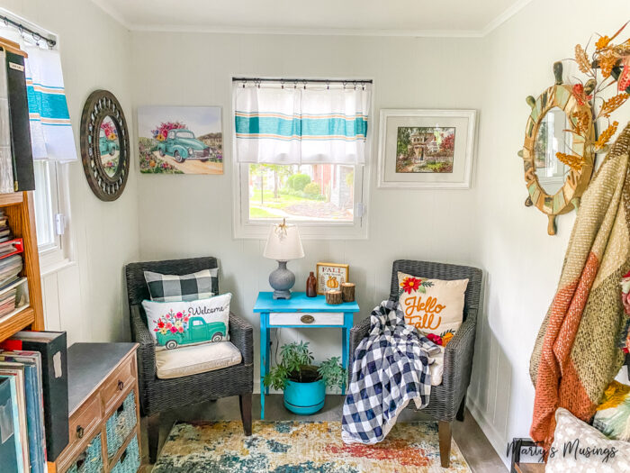 Sunroom filled with blue and orange decorations for fall