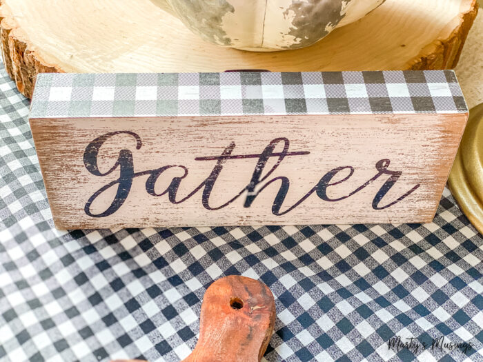 Gather printed on wooden piece with black plaid