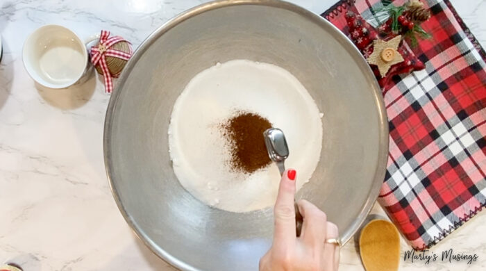 adding ground cloves to metal bowl