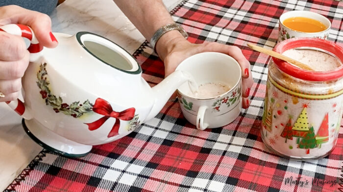 Pour hot water out of Christmas tea pot into mug for Russian Tea