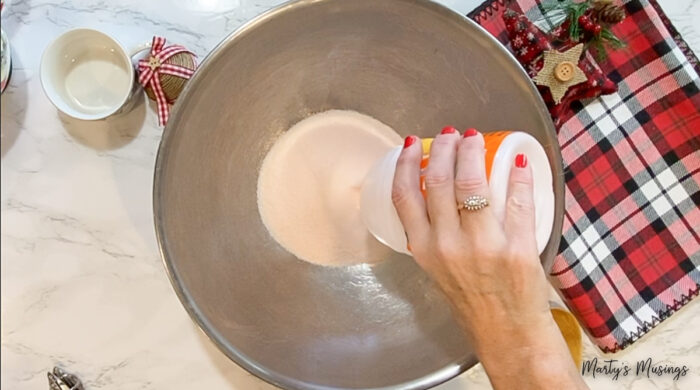 Pouring Tang into large metal bowl