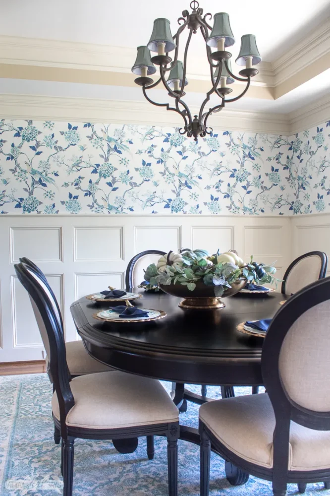 Beautiful blue classic wallpaper in dining room above chair rail