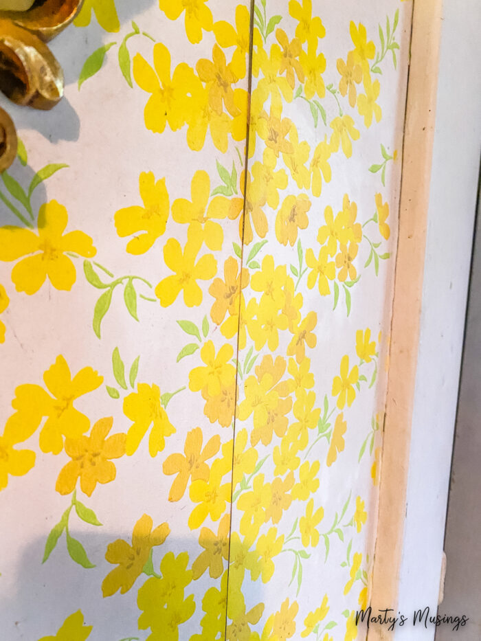 Vintage yellow wallpaper with peeling seams
