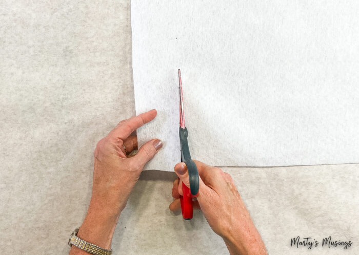 cut white felt with scissors for ornaments