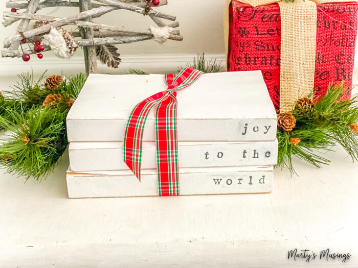 Joy to the world stamped on painted books in Christmas vignette