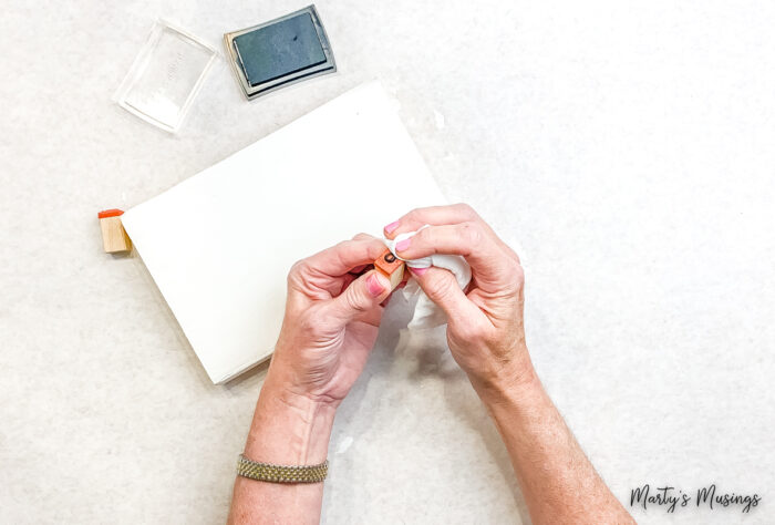 Use rubber stamp to add letters to painted book