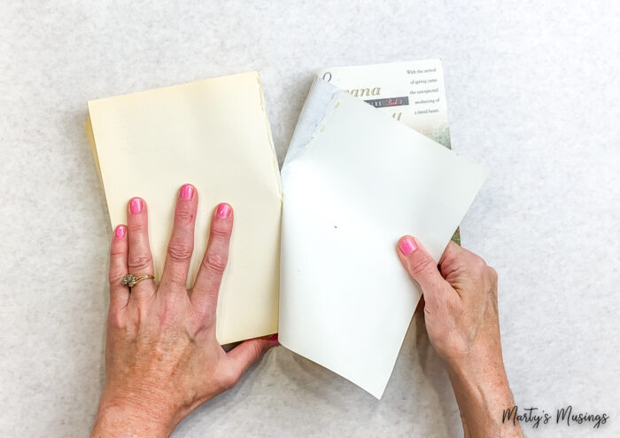 Tearing front cover off paperback book