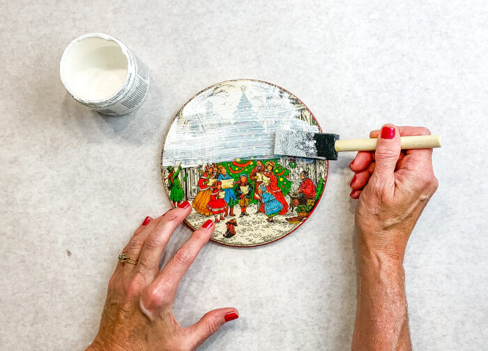 Painting lid of vintage Christmas tin