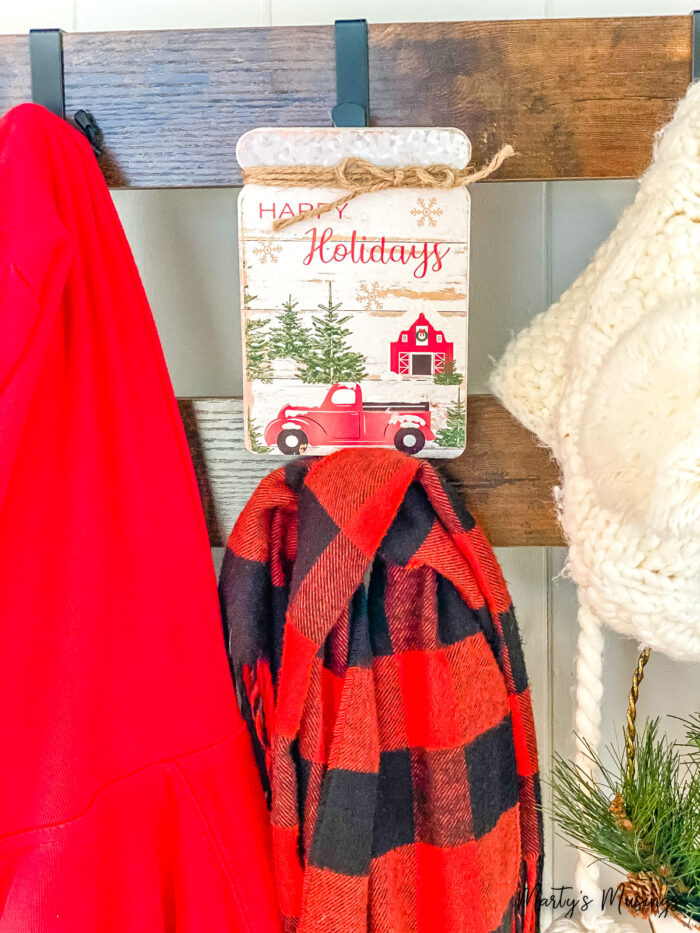 Happy holidays hanging on hook with red buffalo plaid scarf