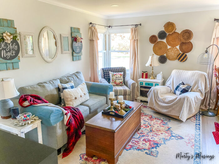 Small living room with blue and red plaid decorated for Christmas