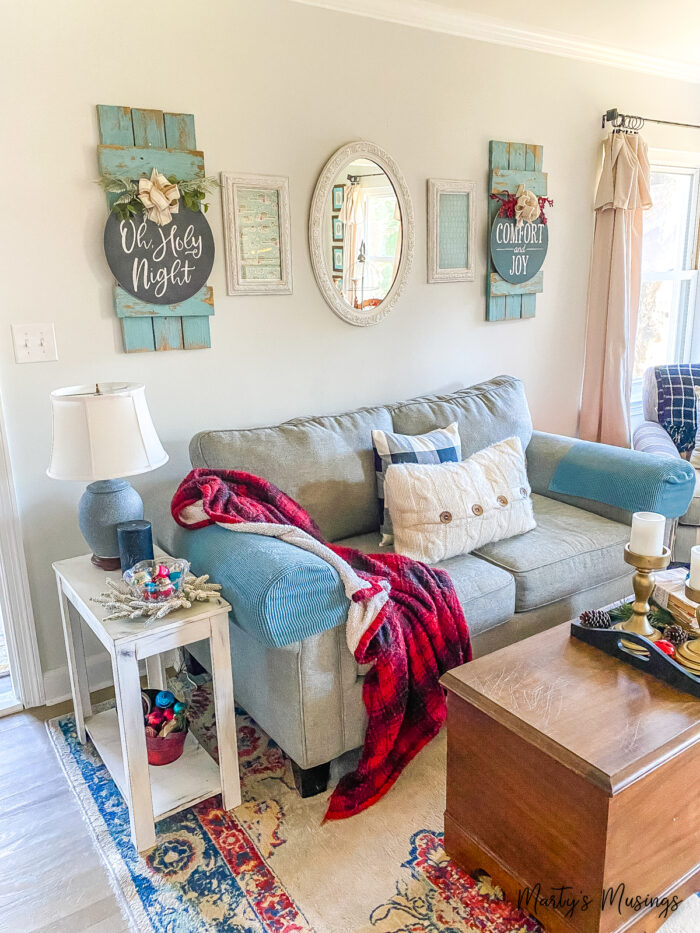 Small living room with blue furniture and red checked Christmas decor