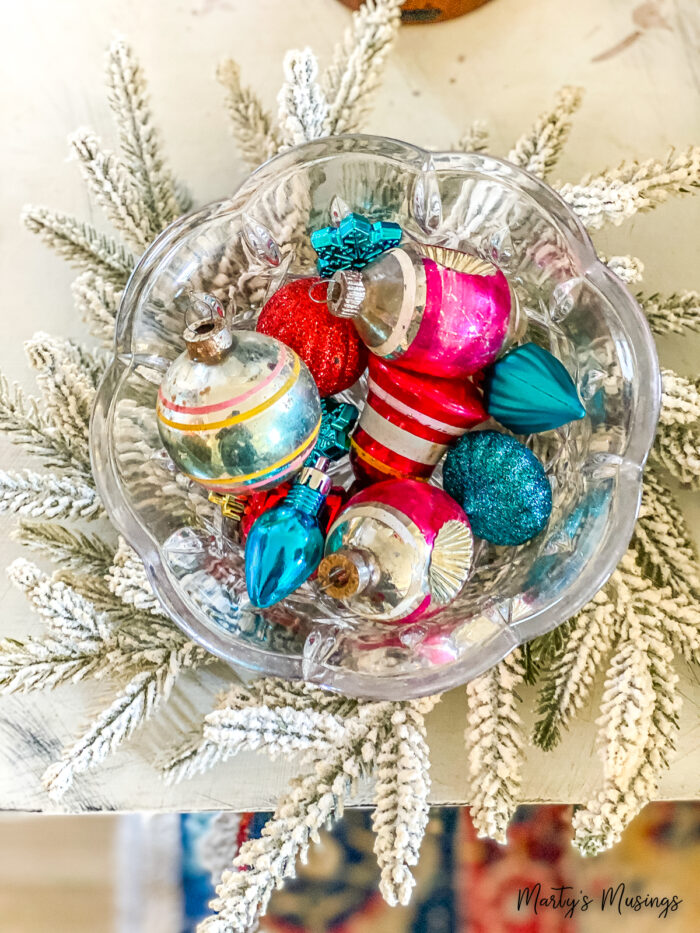 mini flocked wreath with bowl of vintage ornaments