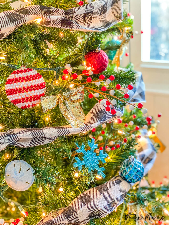 Christmas tree with black and white ribbon and blue and red ornaments