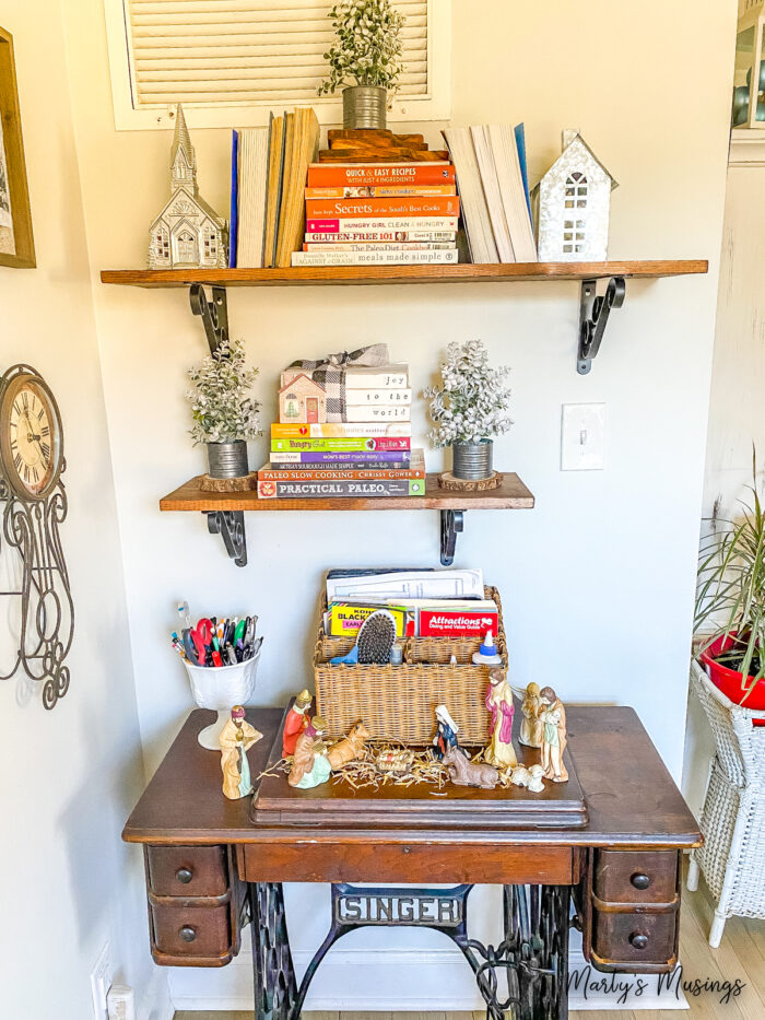 Shelves decorated with silver houses and snowy Christmas trees