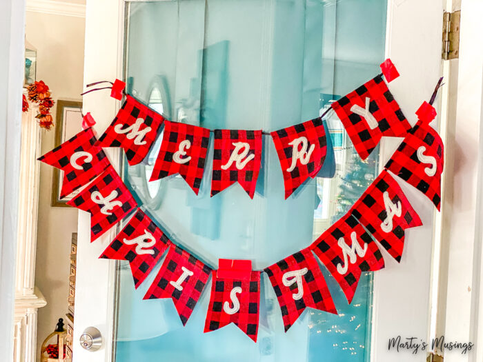 Merry Christmas banner hung on glass door