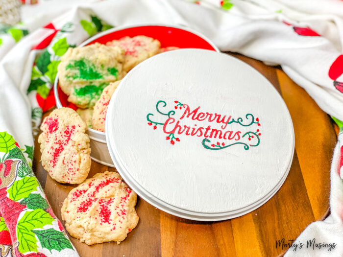 White Merry Christmas tin with sugar cookies inside