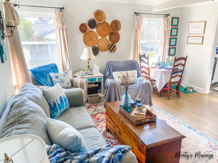 Small living room decorated for winter with snow pillows and blue accents